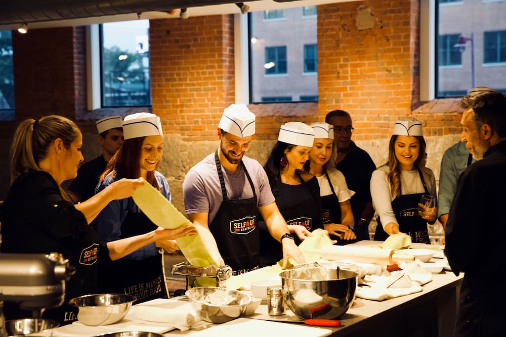 Using Team Building Activities to Reward Your Staff | Team Cooking Pasta
