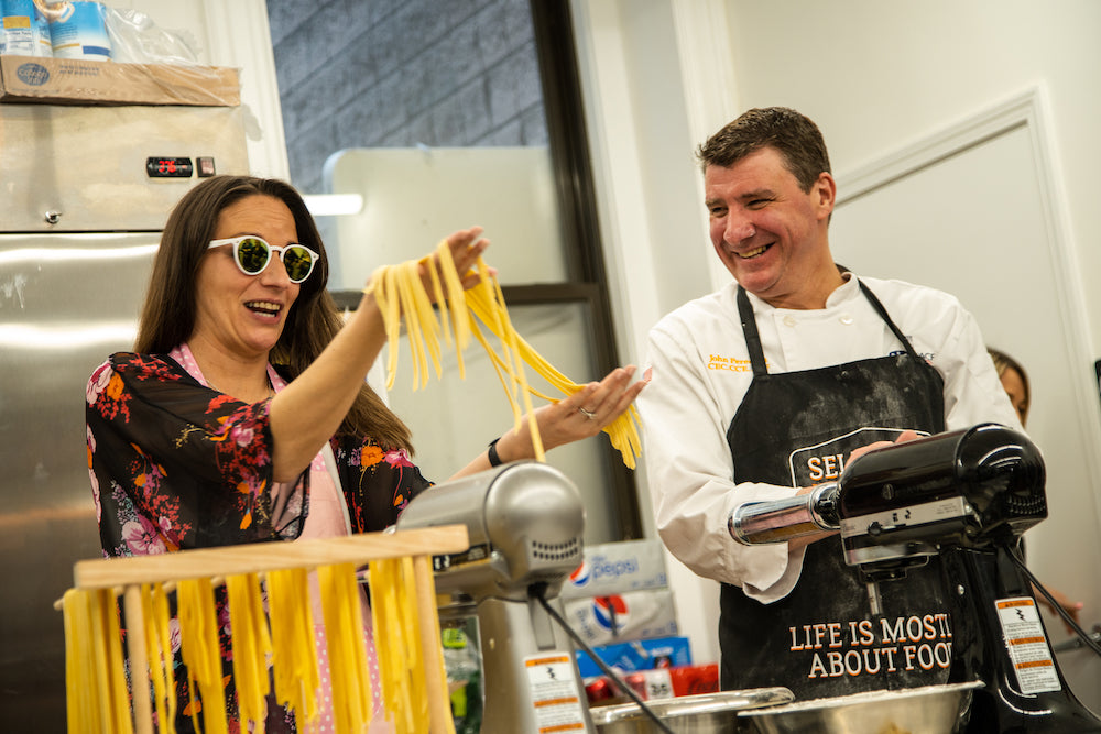 Culinary Arts Selfup | Chef and student cooking pasta